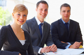 3 office workers sat around a table